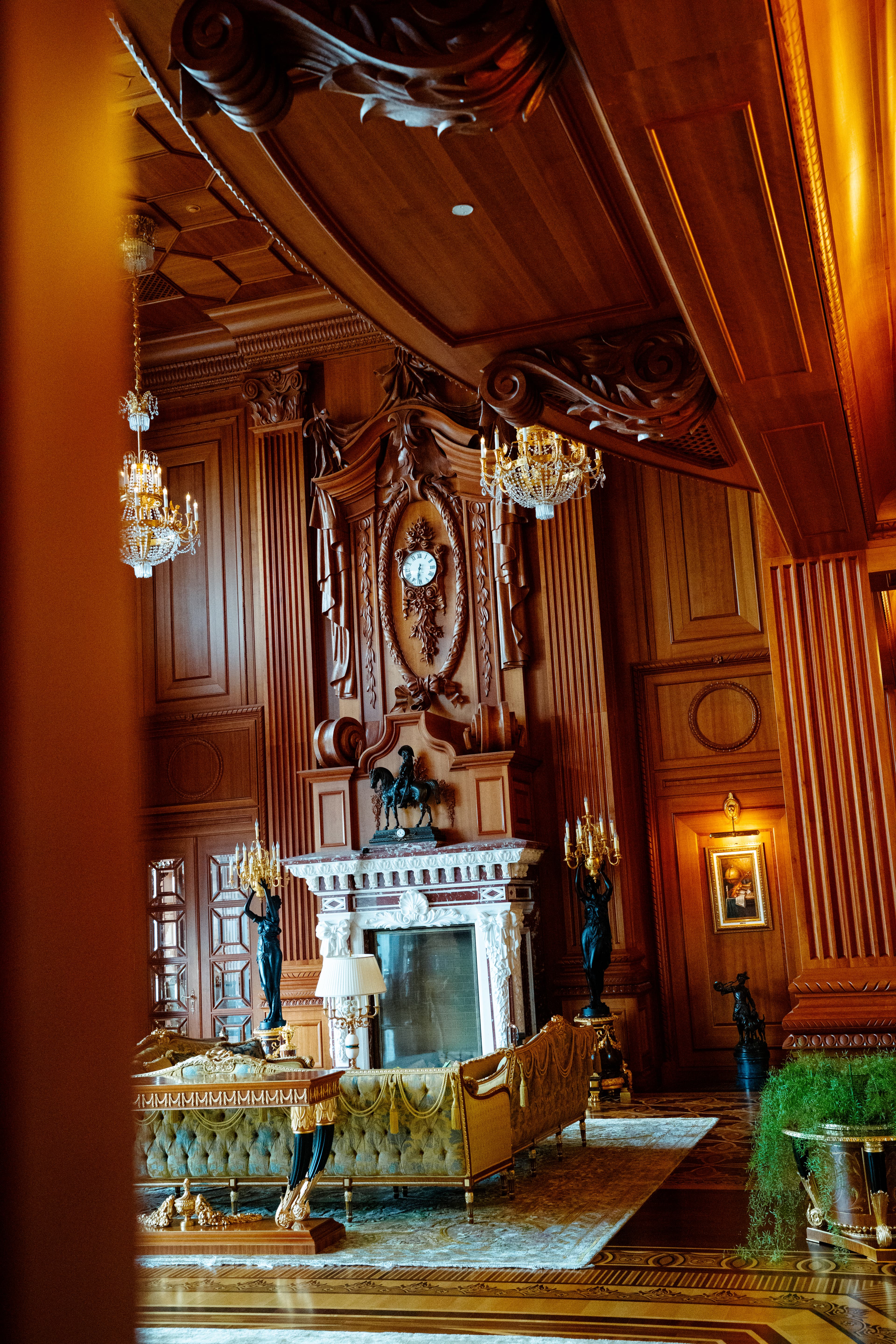 Ornate palace interior with chandeliers and carved wood detailing.