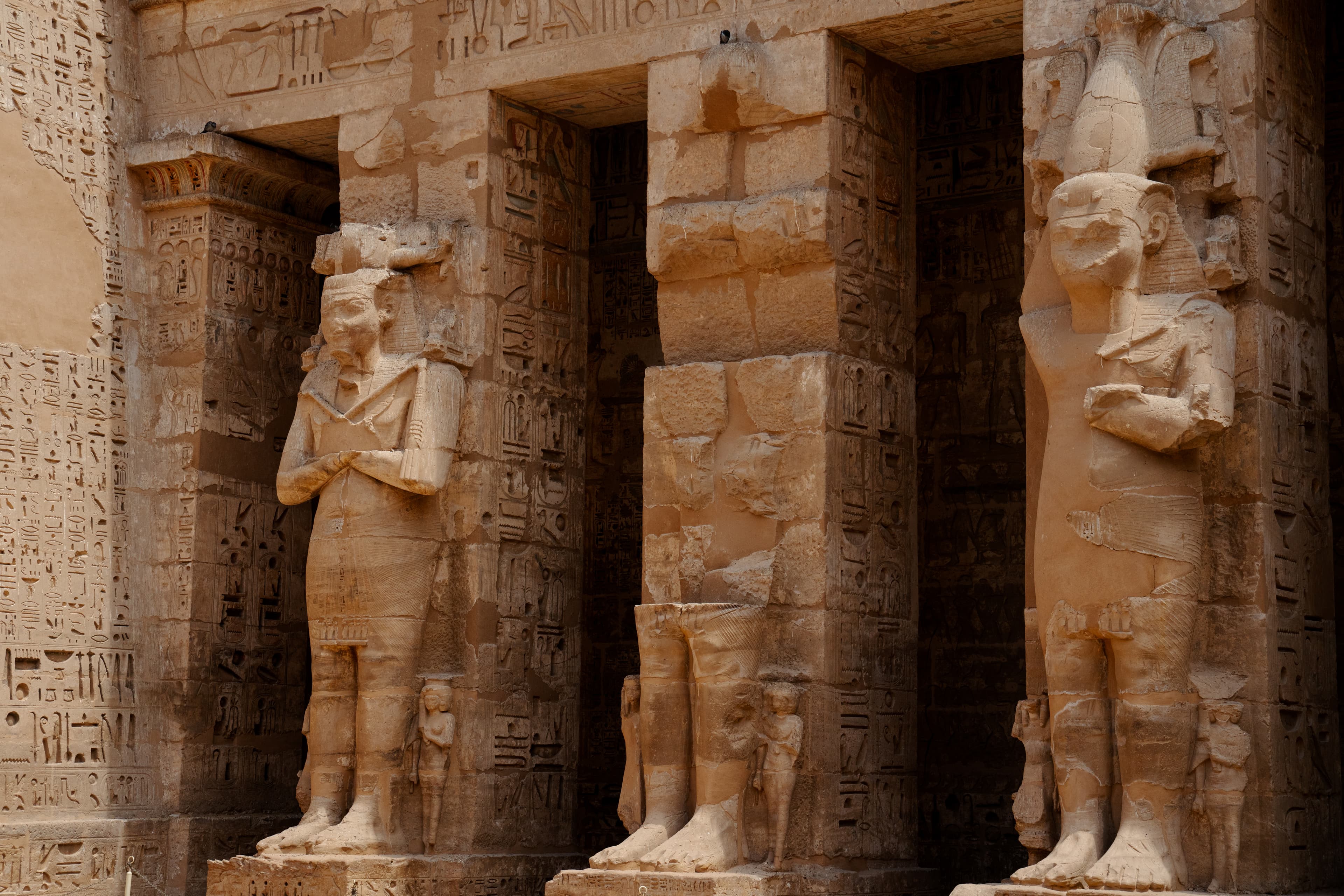 Temple ruins with towering Egyptian columns engraved in hieroglyphs.